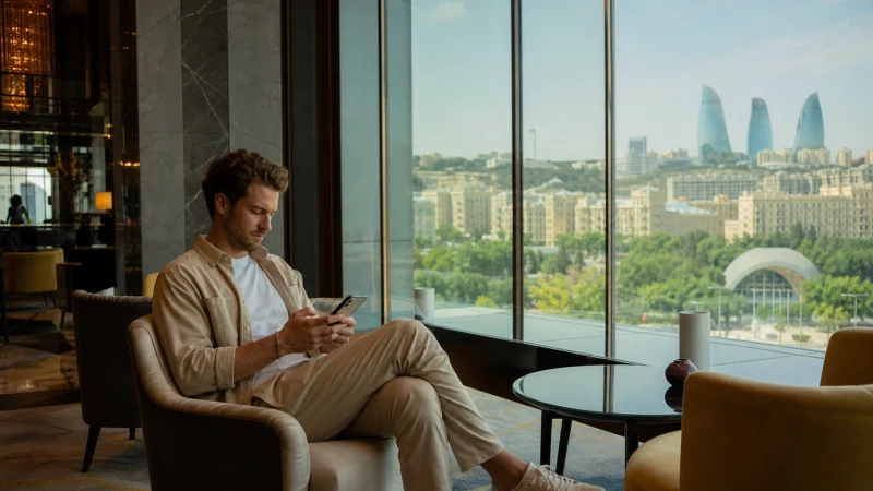 Business traveller using secure mobile internet in Baku