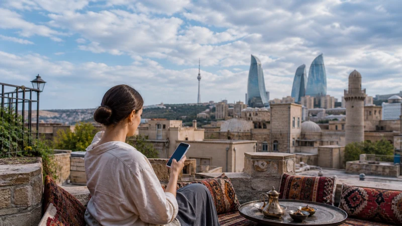 Traveller using a smartphone above Baku Old City