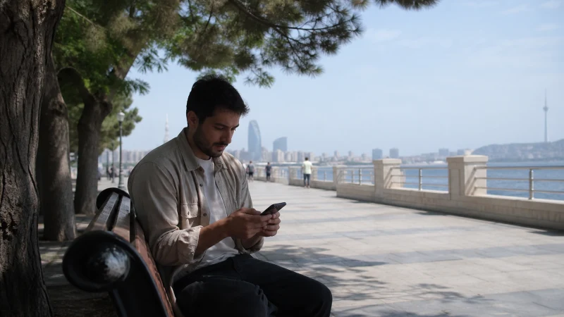 Summer traveller checking mobile data near the Caspian coast