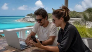 Travel companions using a phone hotspot beside the sea in Eleuthera