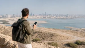 Traveller using a smartphone in Bahrain for bahrain esim coverage