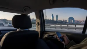 Traveller using mobile internet during a Baku Airport city transfer