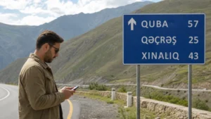 Traveller checking mobile internet on the Baku to Quba route