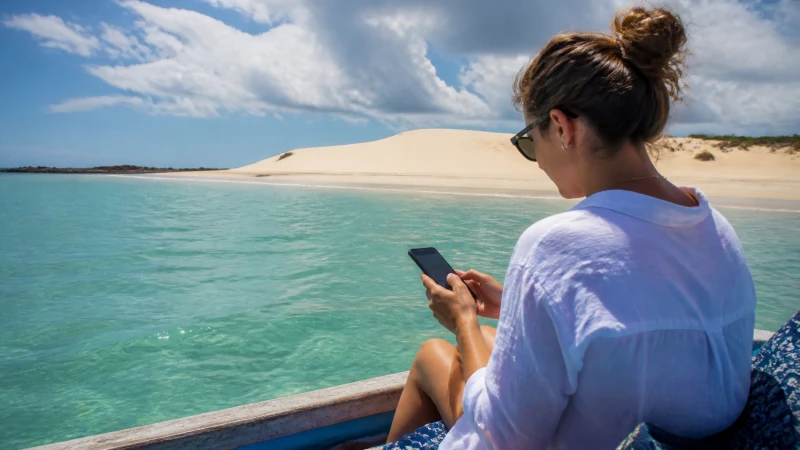 Traveller using a smartphone at Bazaruto Archipelago in Mozambique