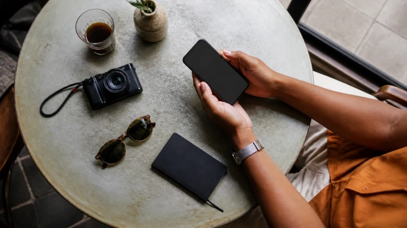 Traveller exploring mobile apps at a cafe in Ghana