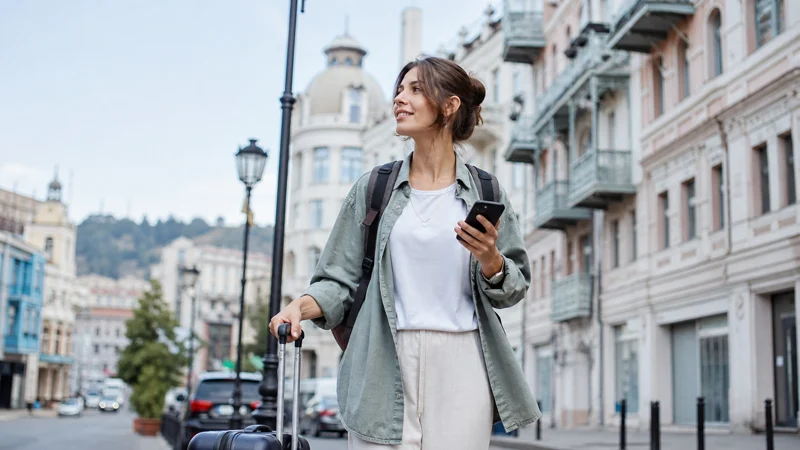 Traveller checking a smartphone on a street in Tbilisi, Georgia