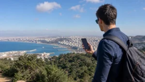 Traveller comparing mobile network coverage on a smartphone in Algeria