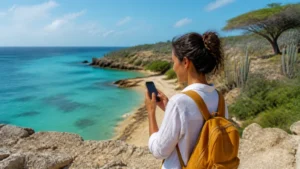 Tourist checking network coverage at a scenic Aruba viewpoint
