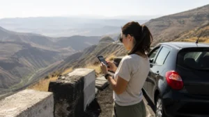 Traveller checking a coverage map on a road through Armenia