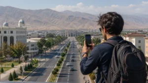 Traveller using a smartphone for mobile internet in bokhtar: esim and business travel guide