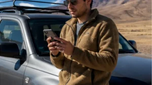 Traveller using a smartphone in Bolivia while researching using a bolivia esim with a rental car