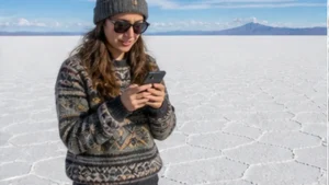 Traveller using a smartphone in Bolivia while researching using a bolivia esim for the uyuni salt flats