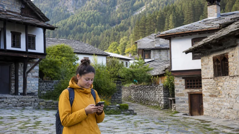 Traveller using a smartphone in a remote Bulgarian village