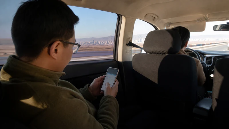 Traveller using a smartphone in Mongolia for chinggis khaan airport to ulaanbaatar internet