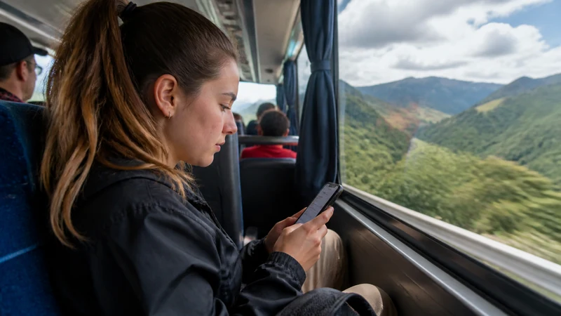 Traveller using a smartphone in Colombia for using maps and mobile data on colombia’s buses