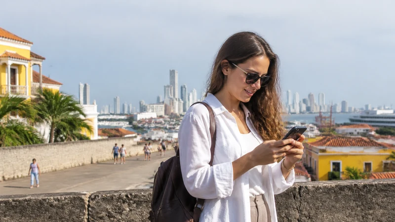 Traveller using a smartphone in Colombia for setting up a colombia esim on iphone