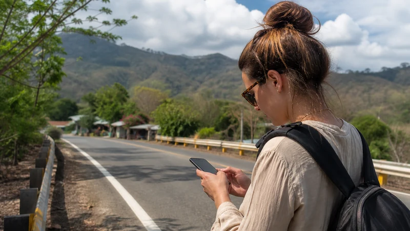 Traveller using a smartphone in Costa Rica for mobile data near the costa rica–nicaragua border
