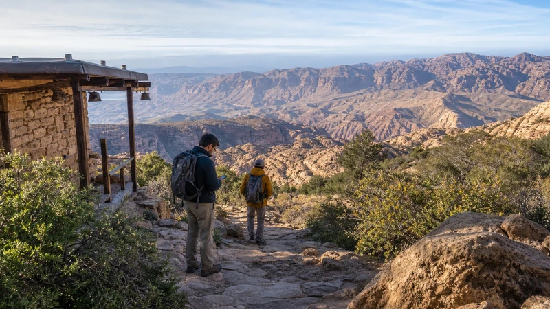 Traveller using a smartphone in Jordan for mobile internet in dana biosphere reserve: esim, wi-fi and travel tips