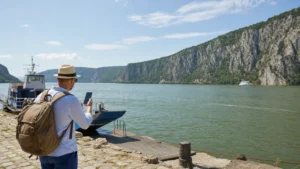Traveller using a smartphone during danube travel in serbia in Serbia.