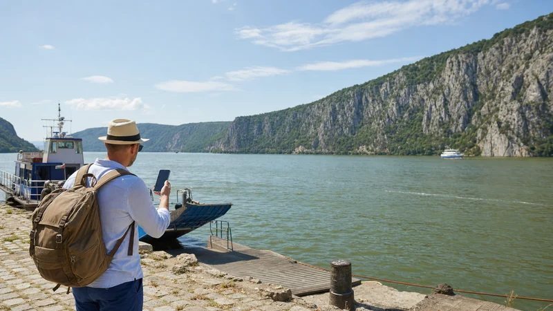 Traveller using a smartphone during danube travel in serbia in Serbia.