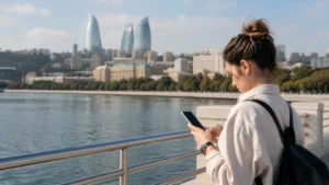 Traveller using a smartphone on the Baku waterfront