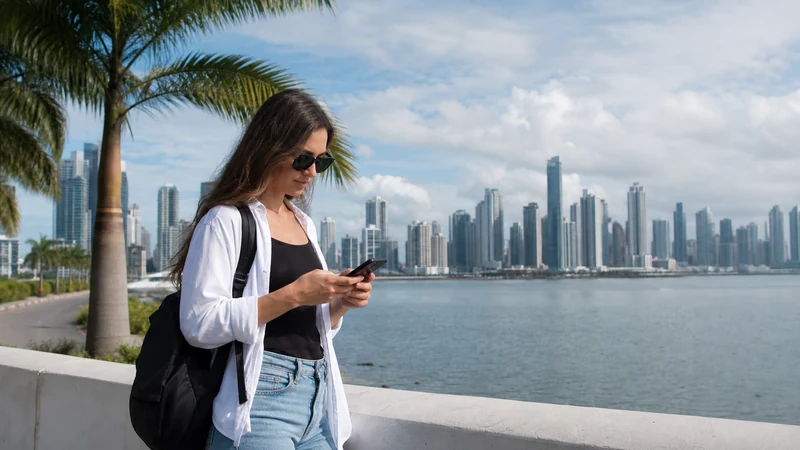 Traveller using a smartphone in Panama for does esim work panama