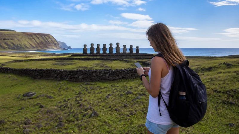 Traveller using a smartphone in Chile for using mobile data on easter island