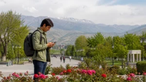 Traveller using a smartphone in green Fergana