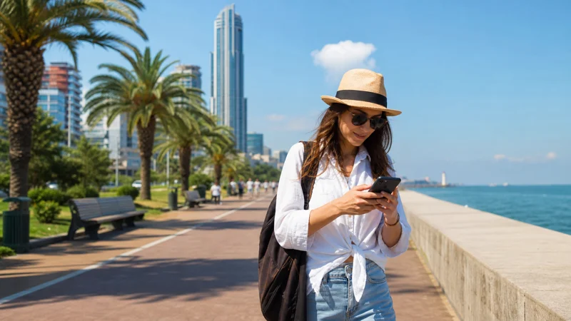 Summer traveller using a smartphone on the Batumi promenade
