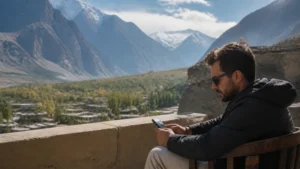 Traveller using a smartphone in the Gilgit mountain valley