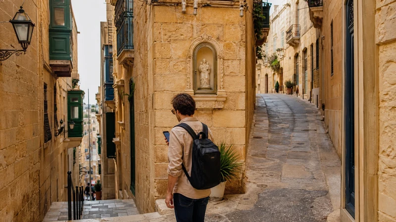 Traveller using a smartphone in Malta while using Google Maps in Malta