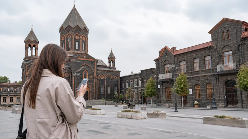 Traveller using a smartphone while using mobile internet in Gyumri
