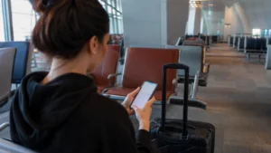 Traveller using a smartphone in Hamad Airport seating area