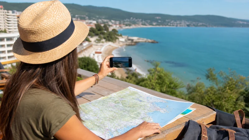 Traveller using a smartphone on the Bulgarian Black Sea coast