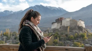 Traveller checking mobile data at a Hunza Valley viewpoint