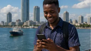 Traveller using mobile internet on a smartphone in Dar es Salaam