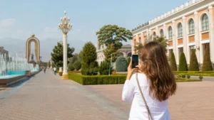 Traveller using a smartphone for internet in dushanbe for tourists: esim, wi-fi and mobile data