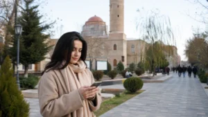 Visitor checking mobile data while sightseeing in Ganja