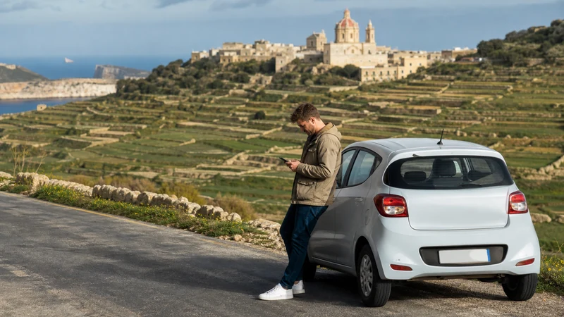 Traveller checking a smartphone during a journey across Gozo