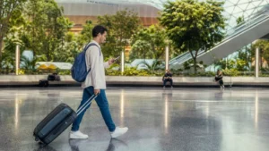 Traveller using a smartphone in Qatar for internet at hamad international airport: wi-fi, sim and esim options