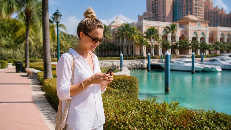 Traveller using a smartphone on Paradise Island Bahamas