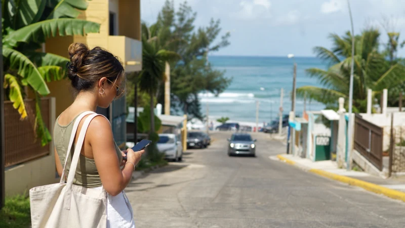 Traveller using a smartphone in Puerto Rico while staying connected in Rincon