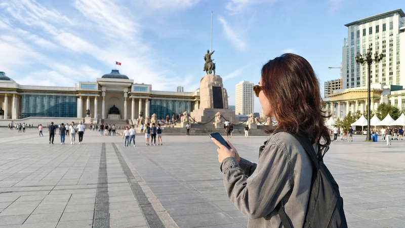 Traveller using a smartphone in Mongolia for internet ulaanbaatar tourists