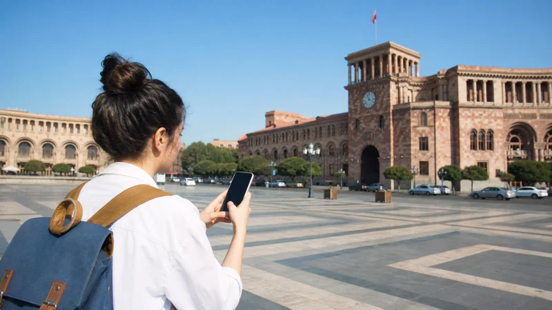 Traveller using a smartphone while staying connected in Yerevan