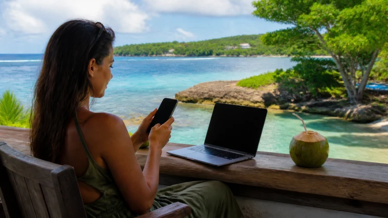Traveller using a smartphone in Jamaica while working remotely from Jamaica