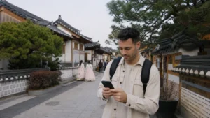 Traveller using mobile navigation in Jeonju Hanok Village