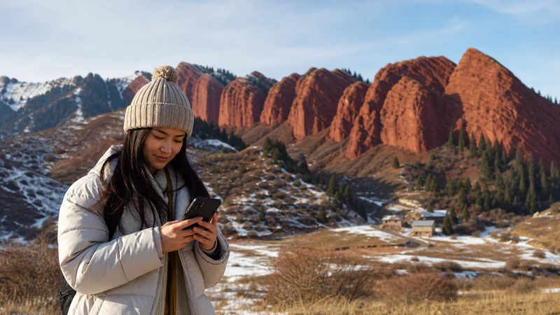 Traveller using a smartphone in Kyrgyzstan for jeti oguz mobile internet
