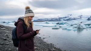 Traveller using a smartphone in Jökulsárlón