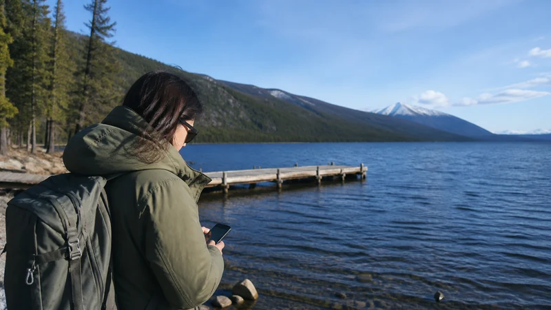 Traveller using a smartphone in Mongolia for khuvsgul lake mobile internet