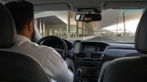 Traveller using a smartphone in a Kuwait setting related to getting mobile data from kuwait airport to the city